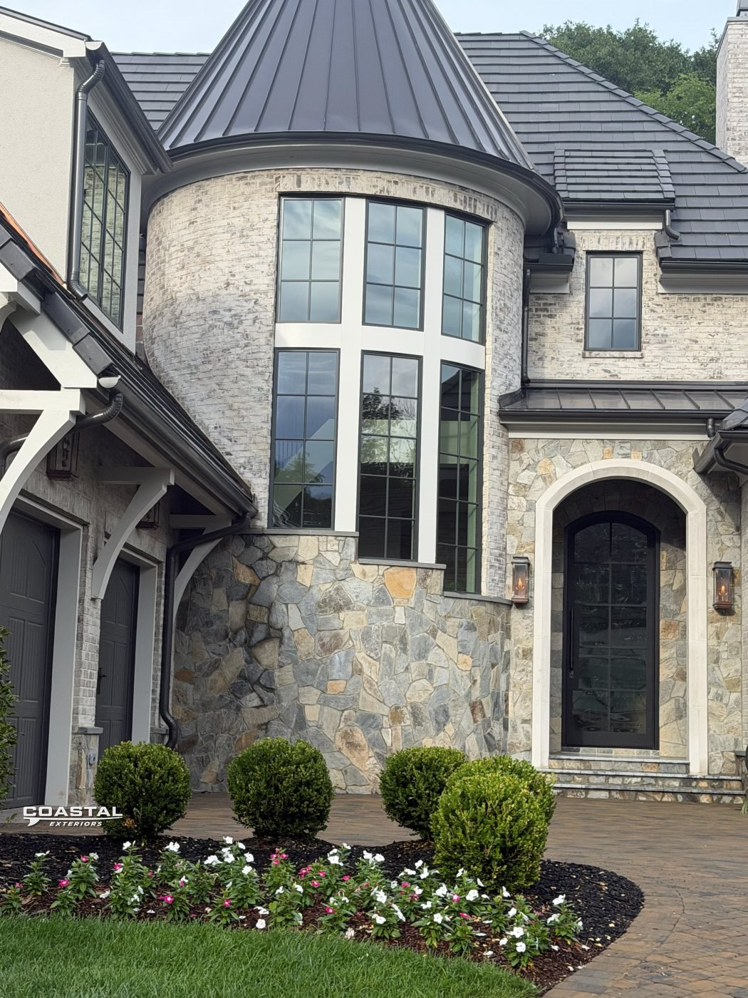 Large stone estate home with freshly cleaned windows